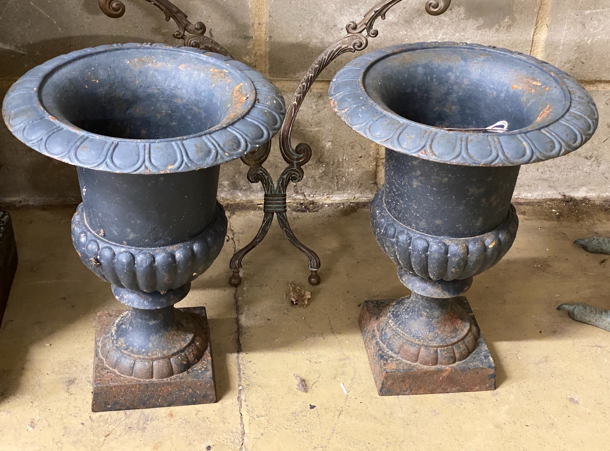 A pair of Victorian style painted cast iron campana garden urns, height 42cm